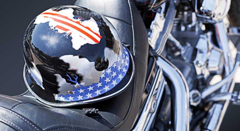 Motorbike motor detail of a Harley Davidson with a helmet on the saddle