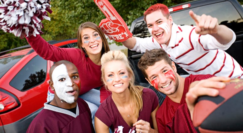 college football fans tailgating and having fun before the game