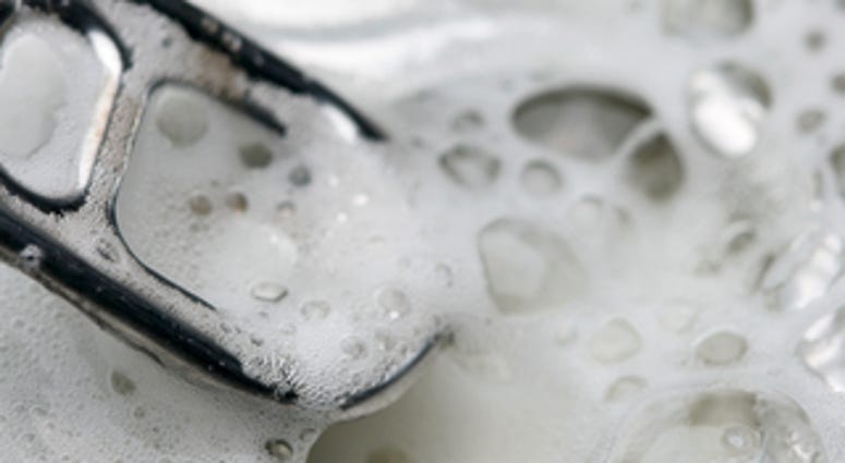 Opened beer can with froth close-up