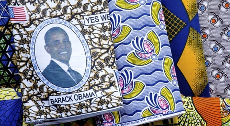 Brightly colored cloth with African patterns including one with the American flag and a portrait of President Obama.