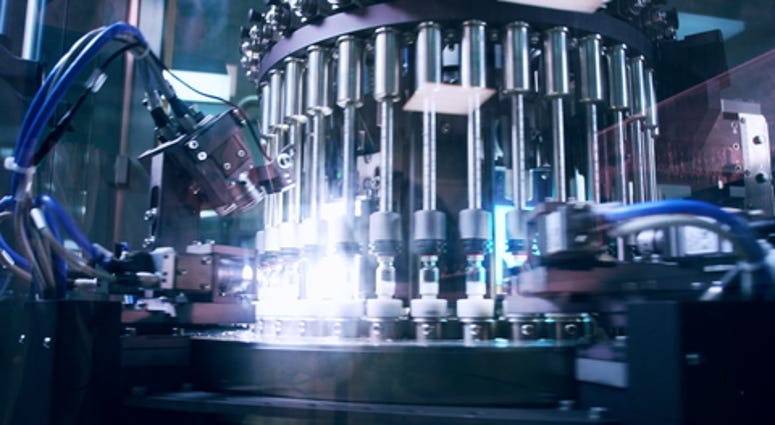 Pharmaceutical manufacturing line at factory. Pharmaceutical quality control. Production equipment at pharmacy industry. Pharmaceutical machine. Medical vials quality control at pharmaceutical factory