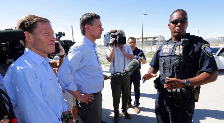 U.S. Sen. Martin Heinrich, D-N.M., center, and U.S. Sen. Richard Blumenthal, D-Ct., left, speak with a Dept. of Homeland Security agent as they arrive to tour the Fabens Port-of-Entry facility which houses tent shelters used to hold separated family membe