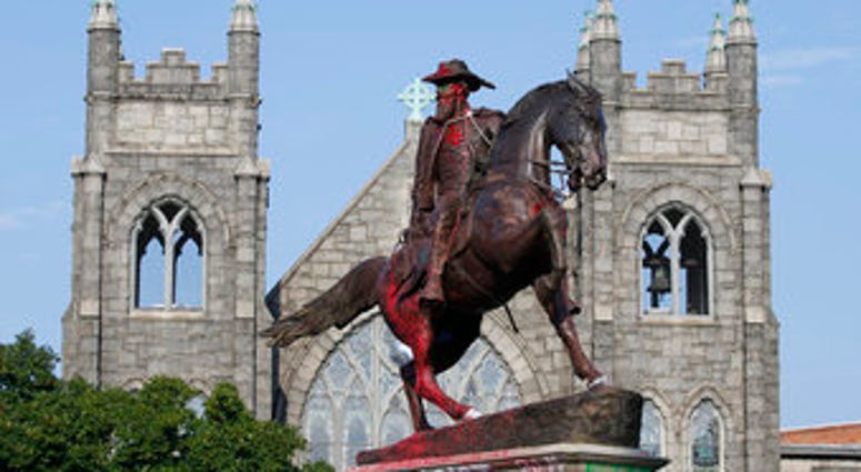 EDS NOTE: OBSCENITY - The statue of Confederate General J.E.B. Stuart is covered in graffiti on Monument Avenue Monday July 6, 2020, in Richmond, Va. The statue is one of several slated for removal by the city of Richmond. (AP Photo/Steve Helber) EDS NOTE: OBSCENITY - The statue of Confederate General J.E.B. Stuart is covered in graffiti on Monument Avenue Monday July 6, 2020, in Richmond, Va. The statue is one of several slated for removal by the city of Richmond. (AP Photo/Steve Helber)