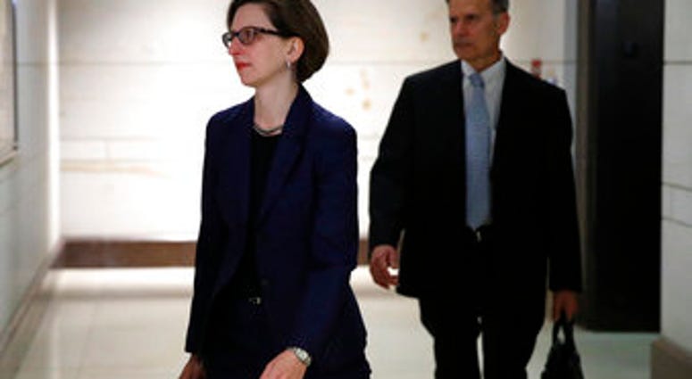 Deputy Assistant Secretary of Defense Laura Cooper, left, arrives to review her testimony as part of the House impeachment inquiry into President Donald Trump, Wednesday, Oct. 30, 2019, on Capitol Hill in Washington. (AP Photo/Patrick Semansky)