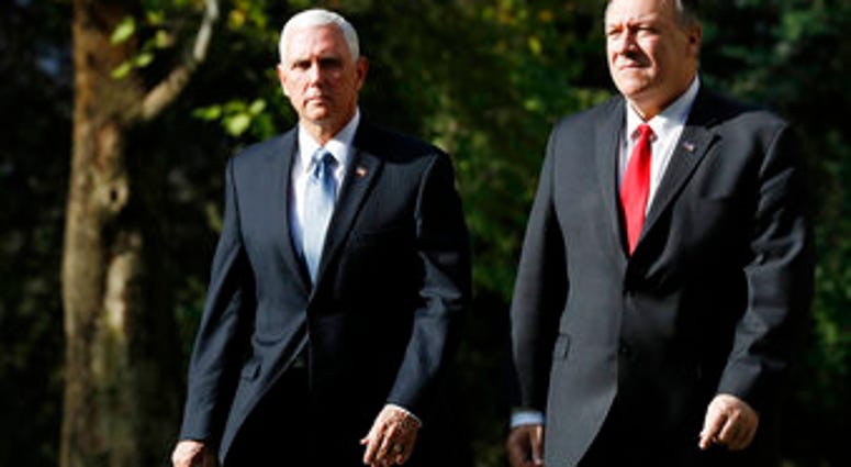 Vice President Mike Pence, left, and Secretary of State Mike Pompeo leave the Ambassador’s Residence as they walk to a motorcade en route to the Presidential Palace for talks on the Kurds and Syria. (AP Photo/Jacquelyn Martin)