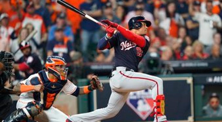 Washington Nationals' Juan Soto hits a two-run scoring double during the fifth inning of Game 1 of the baseball World Series against the Houston Astros Tuesday, Oct. 22, 2019, in Houston. (AP Photo/David J. Phillip)