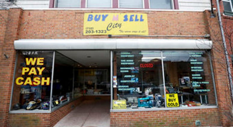 This Sunday, Dec. 15, 2019 photo shows the family-owned Buy n Sell pawn shop searched by the FBI over the weekend in Keyport, N.J. (Ed Murray/NJ Advance Media via AP) This Sunday, Dec. 15, 2019 photo shows the family-owned Buy n Sell pawn shop searched by the FBI over the weekend in Keyport, N.J. (Ed Murray/NJ Advance Media via AP)