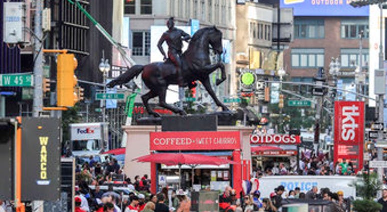 FILE - In this Sept. 27, 2019 file photo, a bronze sculpture, "Rumors of War," by artist Kehinde Wiley, appears in Times Square in New York. (AP Photo/Bebeto Matthews, File) FILE - In this Sept. 27, 2019 file photo, a bronze sculpture, "Rumors of War," by artist Kehinde Wiley, appears in Times Square in New York. (AP Photo/Bebeto Matthews, File)