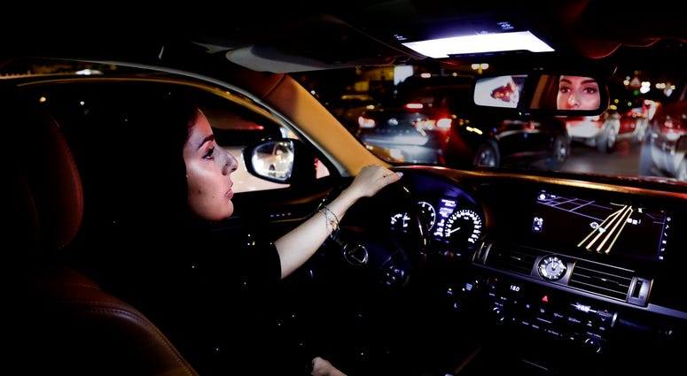 Hessah al-Ajaji drivers her car down the capital's busy Tahlia Street after midnight for the first time in Riyadh, Saudi Arabia, Sunday, June 24, 2018. Saudi women are in the driver's seat for the first time in their country and steering their way through