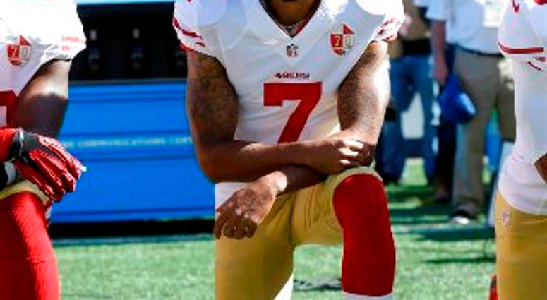 In this Sept. 25, 2016, file photo, San Francisco 49ers' Colin Kaepernick kneels during the national anthem before an NFL football game against the Seattle Seahawks. Kaepernick has a new deal with Nike,