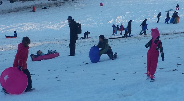 Kids sledding in Bryan Park