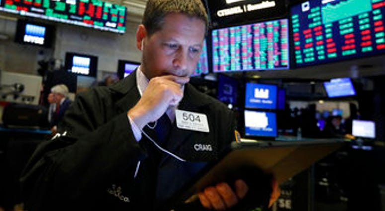 FILE - In this Monday, Oct. 28, 2019, file photo trader Craig Esposito works on the floor of the New York Stock Exchange. The U.S. stock market opens at 9:30 a.m. EDT on Thursday, Oct. 31. (AP Photo/Richard Drew, File)