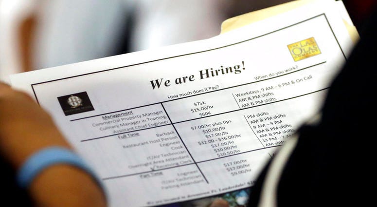 In this Thursday, June 21, 2018 photo, a job applicant looks at job listings for the Riverside Hotel at a job fair hosted by Job News South Florida, in Sunrise, Fla. The Labor Department said Friday, July 6, that the unemployment rate rose to 4.0 percent