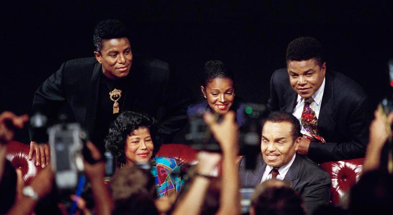 FILE - In this Aug. 30, 1993 file photo, members of the Jackson family, from left, Jermaine Jackson, mother Katherine Jackson, Rebbie Jackson, Joe Jackson, foreground right, and Tito Jackson appear at a press conference in Los Angeles to promote their ben