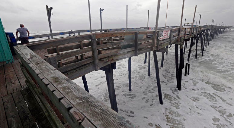 An onlooker checks out the heavy surf at the Avalon Fishing Pier in Kill Devil Hills, N.C., Thursday, Sept. 13, 2018 as Hurricane Florence approaches the east coast. (AP Photo/Gerry Broome) An onlooker checks out the heavy surf at the Avalon Fishing Pier in Kill Devil Hills, N.C., Thursday, Sept. 13, 2018 as Hurricane Florence approaches the east coast. (AP Photo/Gerry Broome)