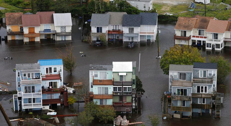 Homes along the New River are flooded as a result of high tides and rain from hurricane Florence which moved through the area in Jacksonville, N.C., Sunday, Sept. 16, 2018. (AP Photo/Steve Helber)