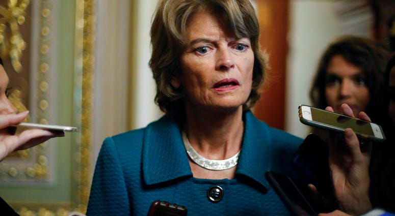 Sen. Lisa Murkowski, R-Alaska, speaks to members of the media after a vote to advance Brett Kavanaugh's nomination to the Supreme Court, on Capitol Hill, Friday, Oct. 5, 2018