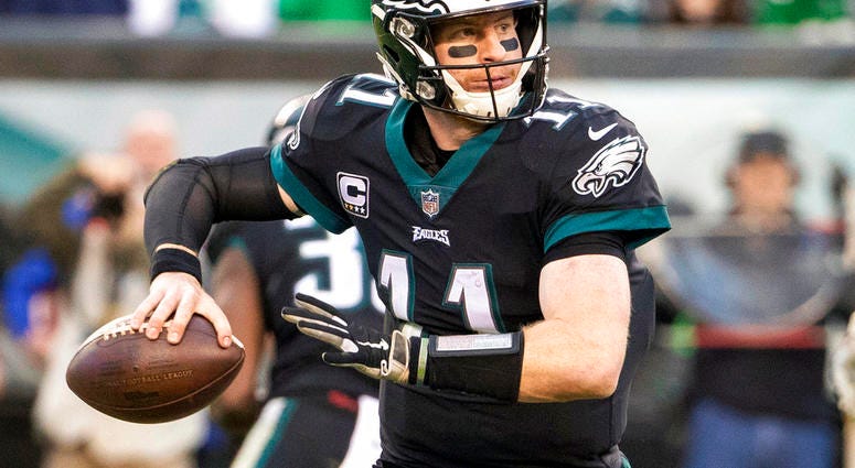In this Nov. 25, 2018, file photo, Philadelphia Eagles quarterback Carson Wentz looks to pass