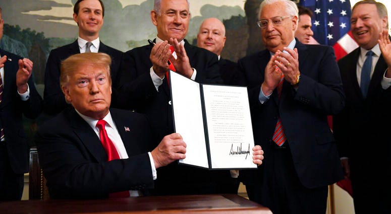 President Donald Trump holds up a signed proclamation recognizing Israel's sovereignty over the Golan Heights. (AP Photo/Susan Walsh) President Donald Trump holds up a signed proclamation recognizing Israel's sovereignty over the Golan Heights. (AP Photo/Susan Walsh)