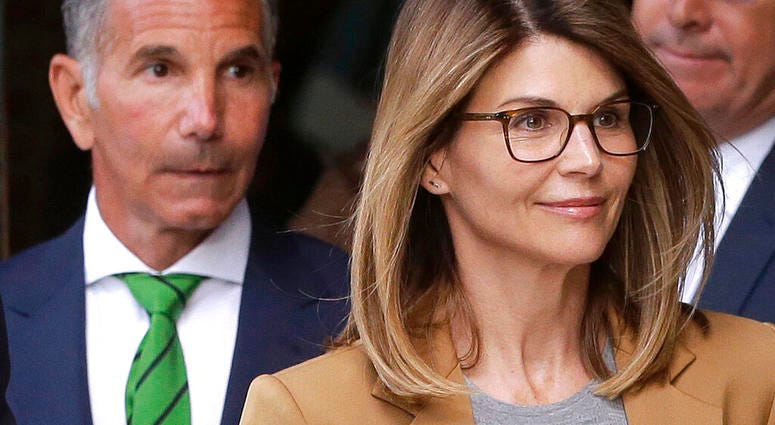 In this April 3, 2019 file photo, actress Lori Loughlin, front, and husband, clothing designer Mossimo Giannulli, left, depart federal court in Boston after facing charges in a nationwide college admissions bribery scandal. (AP Photo/Steven Senne, File)