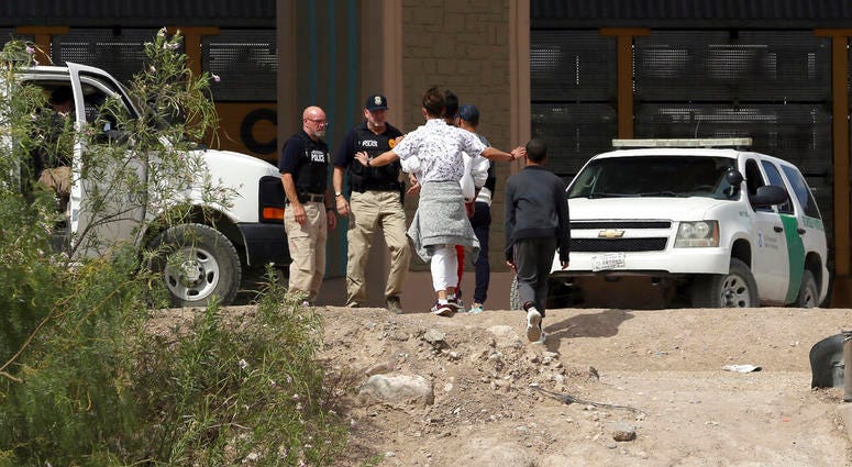 In this July 4, 2019 file photo, a group of asylum seekers cross the border between El Paso, Texas, and Juarez, Chihuahua, Mexico, Thursday, July 4, 2019. (Mark Lambie/The El Paso Times via AP)