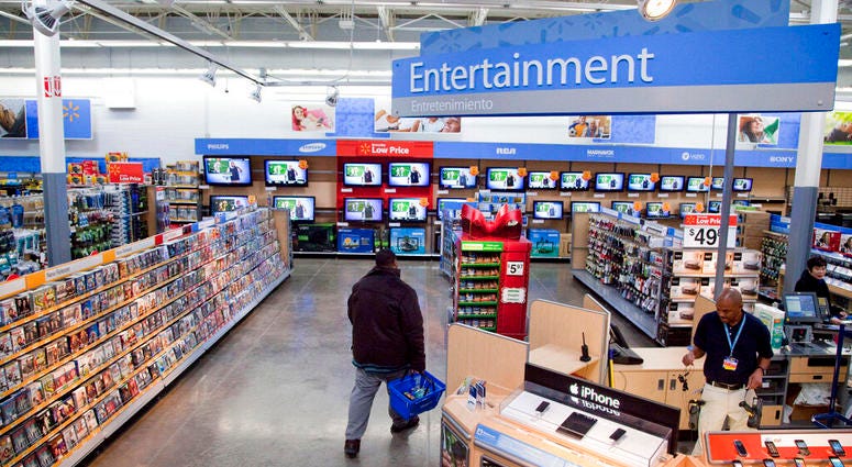 FILE = In this Dec. 15, 2010 file photo, a view of the entertainment section of a Wal-Mart store is seen in Alexandria, Va. Walmart is taking down all signs and displays from its stores that depict violence, following a mass shooting at its El Paso, Texas