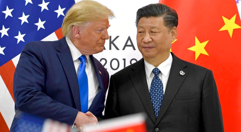 FILE - In this June 29, 2019, file photo, U.S. President Donald Trump, left, shakes hands with Chinese President Xi Jinping during a meeting on the sidelines of the G-20 summit in Osaka,