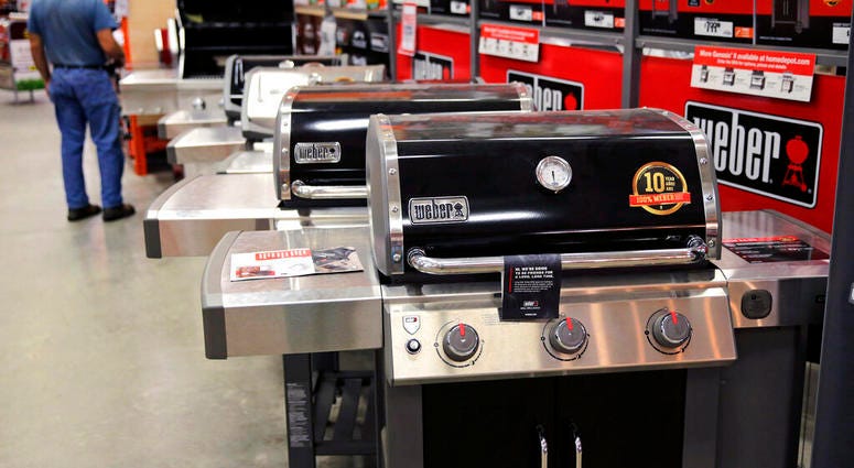 FILE - In this July 11, 2019, file photo Weber grills are displayed at the Home Depot store in Londonderry, N.H. The Home Depot Inc. on Tuesday, Aug. 20, reported fiscal second-quarter net income of $3.48 billion. (AP Photo/Charles Krupa, File)