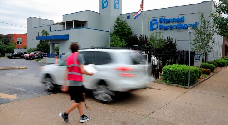 FILE - In this June 21, 2019, file photo, a motorist enters Planned Parenthood of the St. Louis Region and Southwest Missouri. A new Missouri ban on abortions at or after eight weeks of pregnancy won't take effect on August 28 after a federal judge tempor