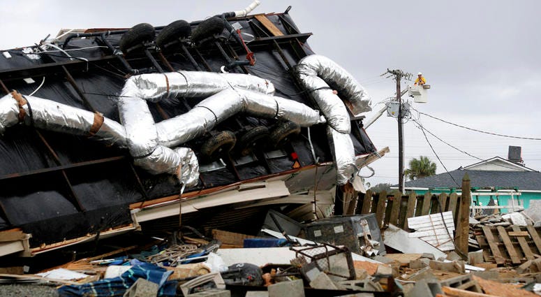 Power company lineman work to restore power after a tornado hit Emerald Isle, N.C. as Hurricane Dorian moved up the East coast on Thursday, Sept. 5, 2019. (AP Photo/Tom Copeland)