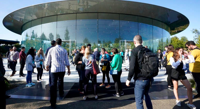 People arrive at Apple for an event to announce new products Tuesday, Sept. 10, 2019, in Cupertino, Calif.