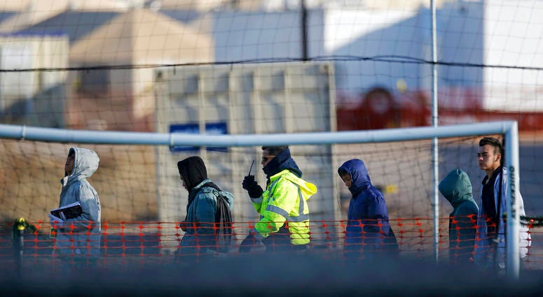 In this Dec. 13, 2018, file photo, teen migrants walk in line inside the Tornillo detention camp in Tornillo, Texas. (AP Photo/Andres Leighton, File)