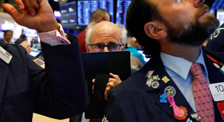 Trader Peter Tuchman, center, works on the floor of the New York Stock Exchange, Monday, Nov. 4, 2019. Stocks are opening higher on Wall Street, pushing major indexes toward more record highs. (AP Photo/Richard Drew)