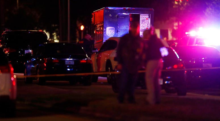Authorities investigate the scene of a shooting Thursday, Dec. 5, 2019, in Miramar, Fla. Four people, including a UPS driver, were killed Thursday after robbers stole the driver’s truck and led police on a chase that ended in gunfire at a busy Florida int