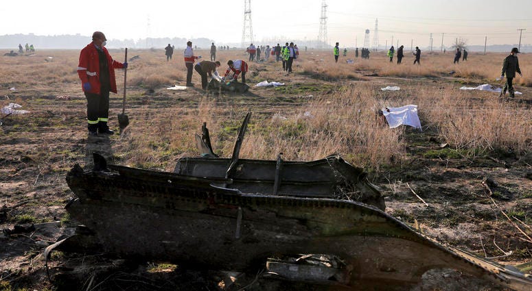 In this Wednesday, Jan. 8, 2020 photo, rescue workers search the scene where a Ukrainian plane crashed in Shahedshahr, southwest of the capital Tehran, Iran.