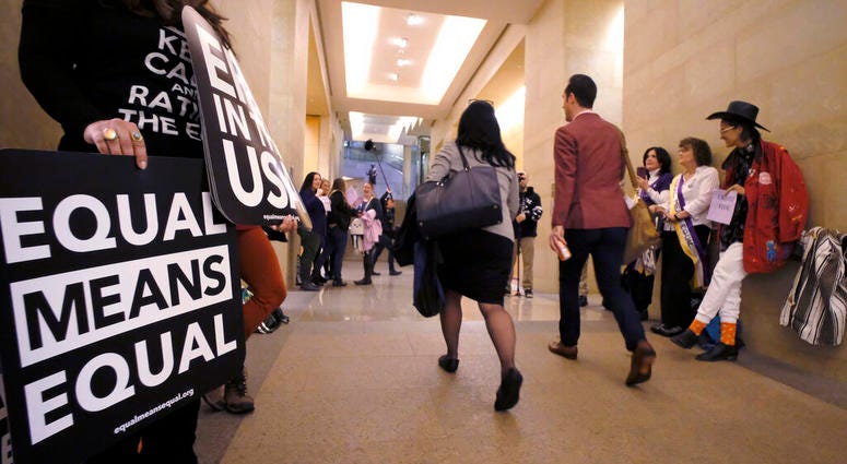 An Equal Rights Amendment supporters yell encouragement to two legislators as they walk down a hallway inside the state Capitol in Richmond, Va., Tuesday, Jan. 14, 2020. (Bob Brown/Richmond Times-Dispatch via AP) An Equal Rights Amendment supporters yell encouragement to two legislators as they walk down a hallway inside the state Capitol in Richmond, Va., Tuesday, Jan. 14, 2020. (Bob Brown/Richmond Times-Dispatch via AP)