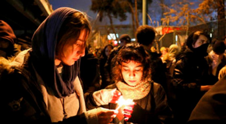 People gather for a candlelight vigil to remember the victims of the Ukraine plane crash, at the gate of Amri Kabir University that some of the victims of the crash were former students of, in Tehran, Iran. (AP Photo/Ebrahim Noroozi) eople gather for a candlelight vigil to remember the victims of the Ukraine plane crash, at the gate of Amri Kabir University that some of the victims of the crash were former students of, in Tehran, Iran. (AP Photo/Ebrahim Noroozi)