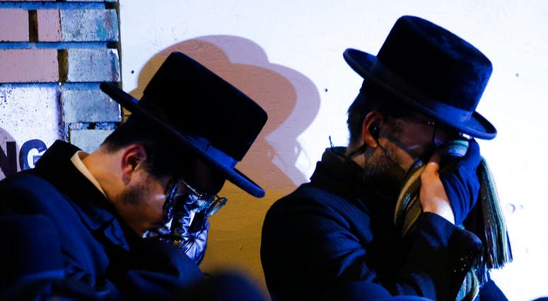 Orthodox Jewish men mourn during the funeral service of Mindel Ferencz who was killed in a kosher market that was the site of a gun battle in Jersey City, N.J., Wednesday, Dec. 11, 2019. (AP Photo/Eduardo Munoz Alvarez) Orthodox Jewish men mourn during the funeral service of Mindel Ferencz who was killed in a kosher market that was the site of a gun battle in Jersey City, N.J., Wednesday, Dec. 11, 2019. (AP Photo/Eduardo Munoz Alvarez)