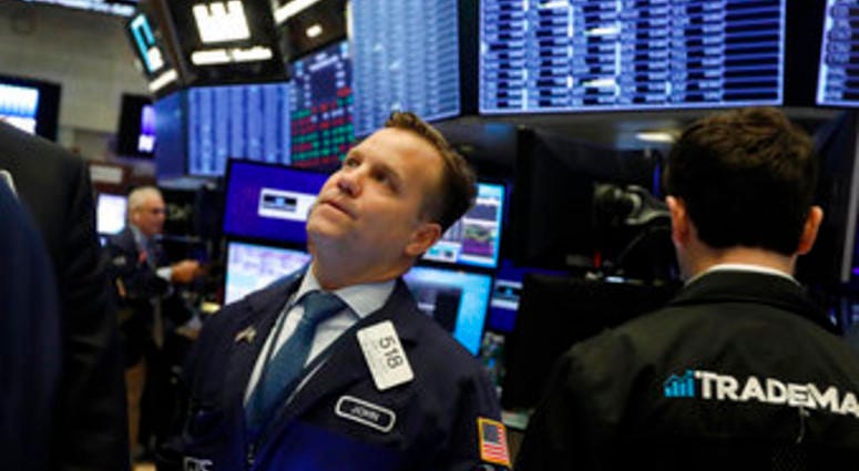 FILE - In this Nov. 14, 2019, file photo trader John Elliott works on the floor of the New York Stock Exchange. (AP Photo/Richard Drew, File) FILE - In this Nov. 14, 2019, file photo trader John Elliott works on the floor of the New York Stock Exchange. (AP Photo/Richard Drew, File)