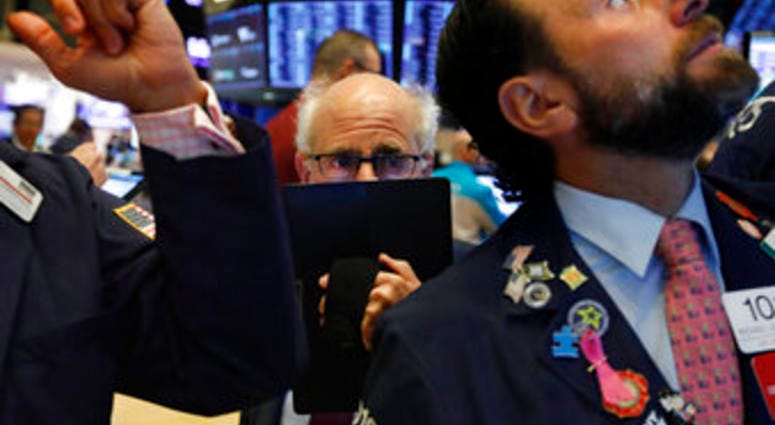 Trader Peter Tuchman, center, works on the floor of the New York Stock Exchange, Monday, Nov. 4, 2019. Stocks are opening higher on Wall Street, pushing major indexes toward more record highs. (AP Photo/Richard Drew)