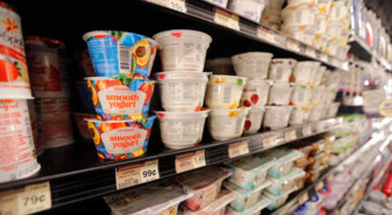 FILE - This July 11, 2018, file photo shows yogurt on display at a grocery store. Despite shelves full of new varieties, from Icelandic to Australian to coconut-based, U.S. yogurt sales are in a multiyear slump. (AP Photo/Gerald Herbert)