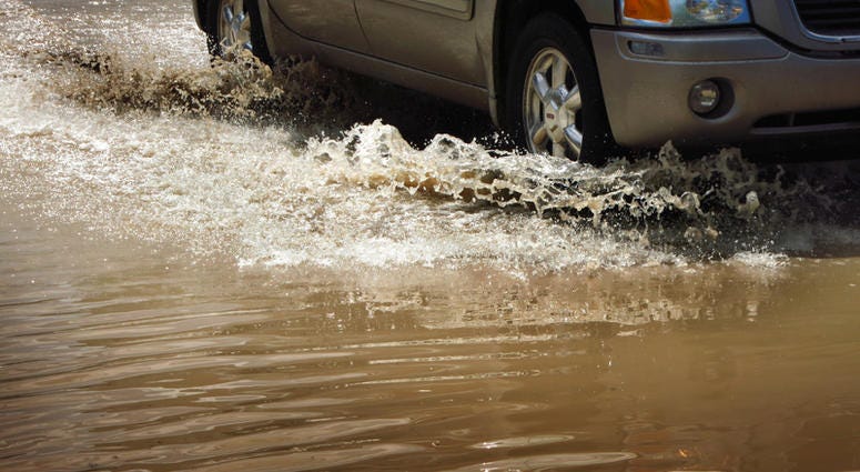 Car in Flood waters (Dreamstime)