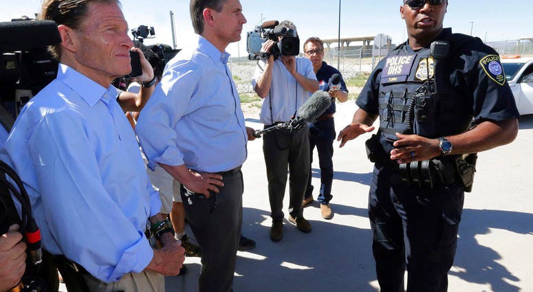 U.S. Sen. Martin Heinrich, D-N.M., center, and U.S. Sen. Richard Blumenthal, D-Ct., left, speak with a Dept. of Homeland Security agent as they arrive to tour the Fabens Port-of-Entry facility which houses tent shelters used to hold separated family membe