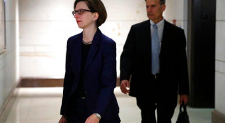 Deputy Assistant Secretary of Defense Laura Cooper, left, arrives to review her testimony as part of the House impeachment inquiry into President Donald Trump, Wednesday, Oct. 30, 2019, on Capitol Hill in Washington. (AP Photo/Patrick Semansky)