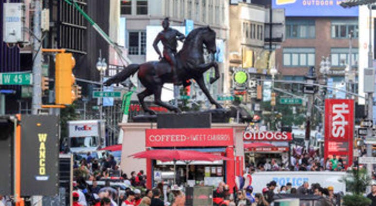 FILE - In this Sept. 27, 2019 file photo, a bronze sculpture, "Rumors of War," by artist Kehinde Wiley, appears in Times Square in New York. (AP Photo/Bebeto Matthews, File) FILE - In this Sept. 27, 2019 file photo, a bronze sculpture, "Rumors of War," by artist Kehinde Wiley, appears in Times Square in New York. (AP Photo/Bebeto Matthews, File)