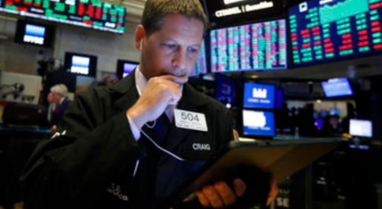FILE - In this Monday, Oct. 28, 2019, file photo trader Craig Esposito works on the floor of the New York Stock Exchange. The U.S. stock market opens at 9:30 a.m. EDT on Thursday, Oct. 31. (AP Photo/Richard Drew, File)