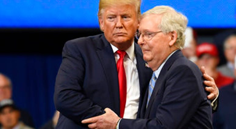 President Donald Trump, left, hugs Senate Majority Leader Mitch McConnell of Ky., right, as he comes up on stage during a campaign rally in Lexington, Ky., Monday, Nov. 4, 2019. (AP Photo/Susan Walsh)