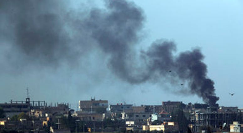 n this photo taken from the Turkish side of the border between Turkey and Syria, in Akcakale, Sanliurfa province, southeastern Turkey, smoke billows from targets in Tel Abyad, Syria (AP Photo/Lefteris Pitarakis)