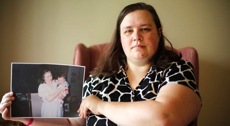 Heidi Clark holds a photograph showing her daughter at her home in Orem, Utah, on Friday, May 18, 2018. Clark became pregnant at 16 and married soon after, under pressure from her boyfriend's religious community of Seventh-Day Adventists in Pennsylvania,