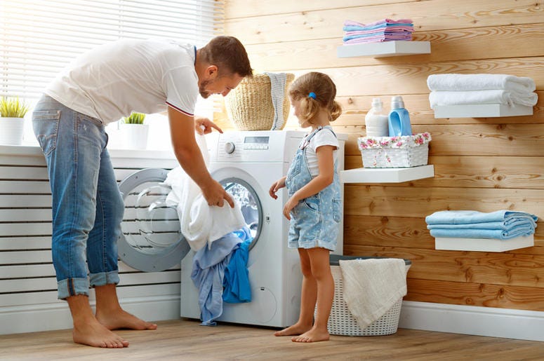 Happy family man father householder and child in laundry with Happy family man father householder and child in laundry with
